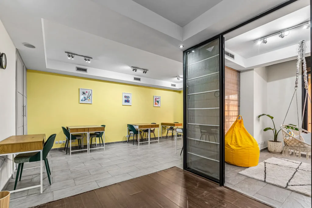 Open workspace with yellow accents and glass partitions