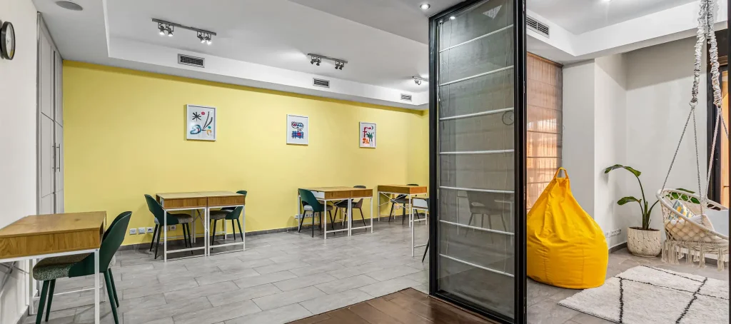 Open workspace with yellow accents and glass partitions
