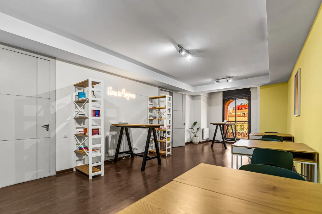 Second open space with a wooden desk and shelves