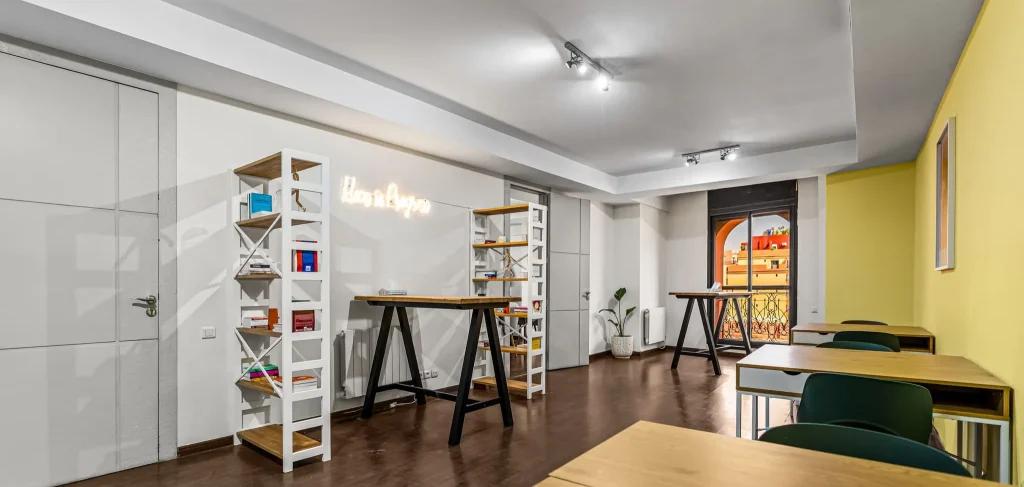 Second open space with a wooden desk and shelves