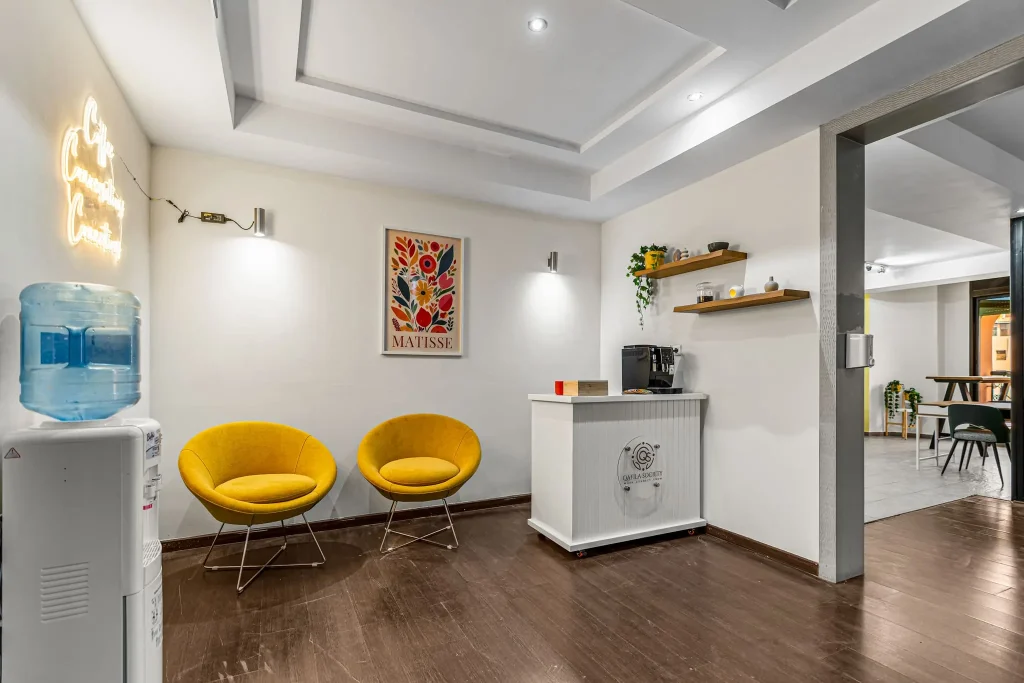 Coffee corner with yellow chairs and framed artwork