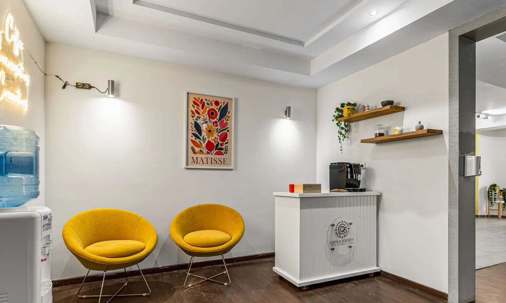 Coffee corner with yellow chairs and framed artwork