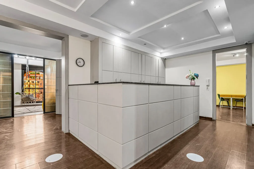 Reception and welcome area with a white counter at Qafila Society