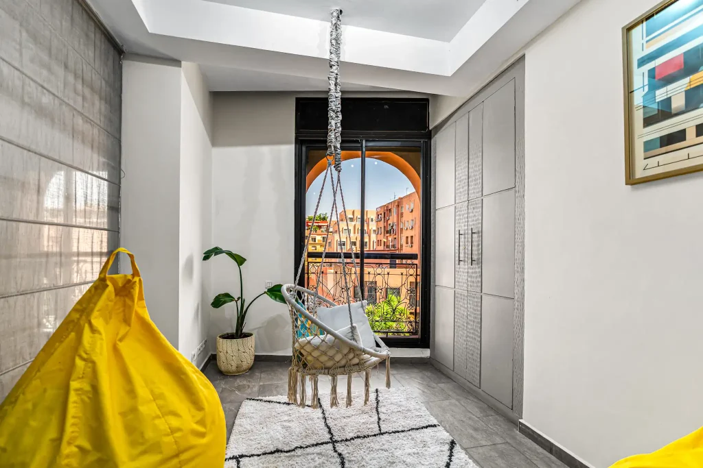 Bright coworking zone with a large arched window at Qafila Society