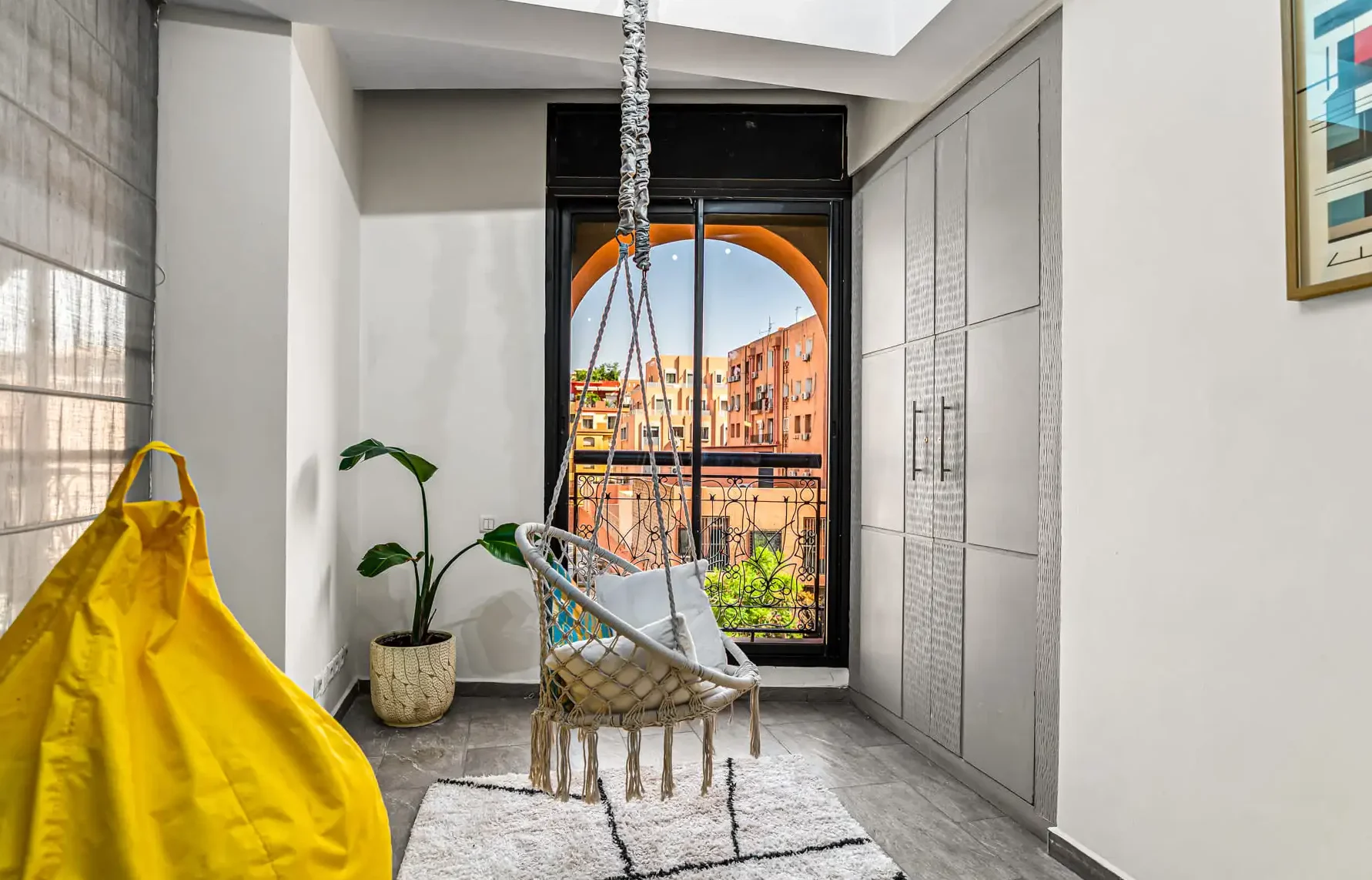 Bright coworking zone with a large arched window at Qafila Society